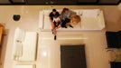 aerial view of family in their living room with cleaning robot on floor